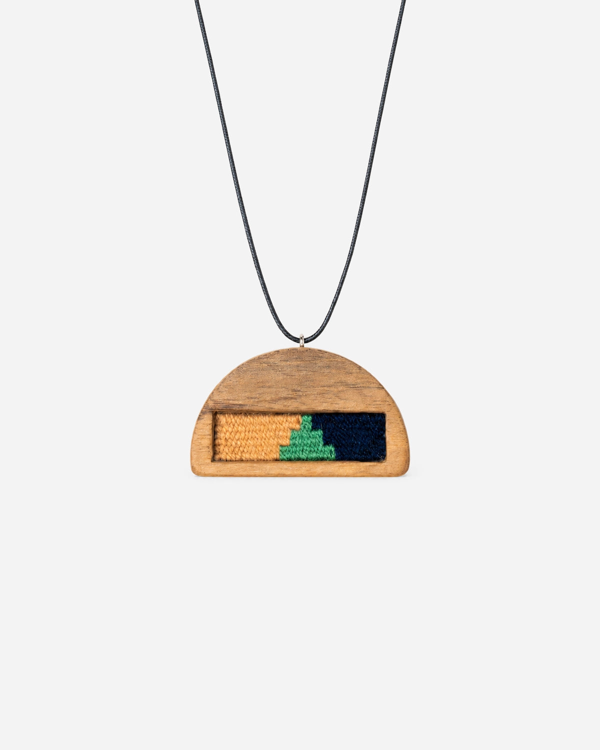 Golden Dawn Kilim Necklace with yellow, green and navy weaving in a half-moon walnut frame on a black cord.
