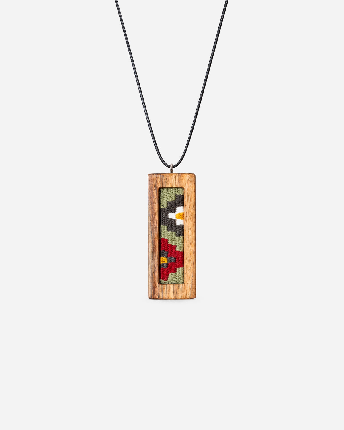 Rose Garden Kilim Necklace with sage, red and white geometric weaving in a slim walnut frame on a black cord.